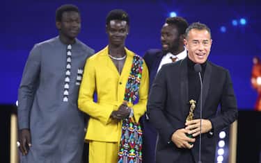 ROME, ITALY - MAY 03: Seydou Sarr, Moustapha Fall, Mamadou Kouassi and Matteo Garrone receive the David di Donatello for Best Director Award during the show during the 69th David Di Donatello at Cinecitta Studios on May 03, 2024 in Rome, Italy. (Photo by Daniele Venturelli/WireImage)