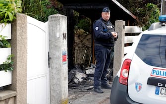 A municipal police officer stands in front of the damaged home of the Mayor of l'Hay-les-Roses Vincent Jeanbrun, in l'Hay-les-Roses, a suburb of Paris on July 2, 2023, after rioters rammed a vehicle into the building injuring the Mayor's wife and one of his children overnight, during continued disturbances across France after a 17-year-old man was killed by police in Nanterre, a western suburb of Paris on June 27. Mayor Vincent Jeanbrun wrote on Twitter that protesters "rammed a car" into his home before "setting a fire" while his family slept. (Photo by Geoffroy Van der Hasselt / AFP) (Photo by GEOFFROY VAN DER HASSELT/AFP via Getty Images)