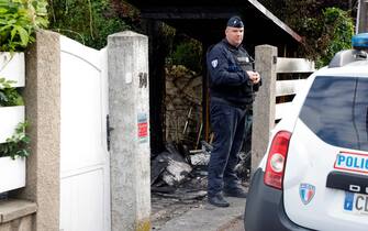 A municipal police officer stands in front of the damaged home of the Mayor of l'Hay-les-Roses Vincent Jeanbrun, in l'Hay-les-Roses, a suburb of Paris on July 2, 2023, after rioters rammed a vehicle into the building injuring the Mayor's wife and one of his children overnight, during continued disturbances across France after a 17-year-old man was killed by police in Nanterre, a western suburb of Paris on June 27. Mayor Vincent Jeanbrun wrote on Twitter that protesters "rammed a car" into his home before "setting a fire" while his family slept. (Photo by Geoffroy Van der Hasselt / AFP) (Photo by GEOFFROY VAN DER HASSELT/AFP via Getty Images)