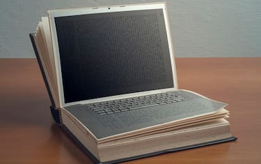 Book on a laptop.Digital composite