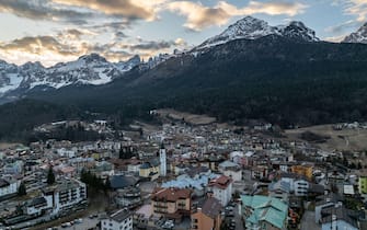 Aerial drone view of Andalo town with mountains background in winter. Ski resort Paganella Andalo, Trentino-Alto Adige, Italy., Italian Dolomites,.Pagnella valley. Snow covered Italian Dolomites at winter.