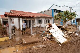 MUÃ UM, BRAZIL - SEPTEMBER 7: Resident clear out furniture covered in mud affected by floods outside their home in the aftermath of the tropical cyclone on September 7, 2023 in MuÃ§um, Brazil. An extratropical cyclone hits the southern region of Brazil flooding more than 60 cities. According to local authorities, death toll nears 40 and thousands are displaced. (Photo by Marcelo Oliveira/Getty Images)