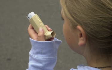 Young girl using asthma inhaler. (Photo by Jeff Overs/BBC News & Current Affairs via Getty Images)