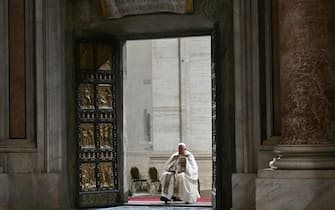 Pope Francis opens the Holy Door of St Peter's Basilica in the Vatican to mark the start of the Catholic Jubilee Year, on December 24, 2024. - Pope Francis marks Christmas Eve with a special ceremony launching Jubilee 2025, a year of Catholic celebrations set to draw more than 30 million pilgrims to Rome. Over the next 12 months, pilgrims will pass through the large and imposing bronze door, which is normally closed, by tradition benefiting from a "plenary indulgence", a type of forgiveness for their sins. (Photo by Alberto PIZZOLI / POOL / AFP)