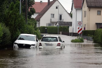 02 June 2024, Bavaria, Offingen: Cars standing in the flood waters of the Mindel in a residential area. Photo: Karl-Josef Hildenbrand/dpa - ATTENTION: One license plate has been pixelated for legal reasons (Photo by Karl-Josef Hildenbrand/picture alliance via Getty Images)
