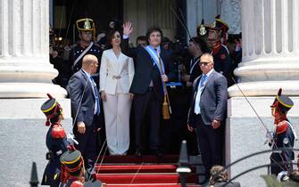Argentina's new president Javier Milei waves next to his vice president Victoria Villarruel after being sworn in during his inauguration ceremony at the Congress in Buenos Aires on December 10, 2023. Libertarian economist Javier Milei was sworn in Sunday as Argentina's president, after a resounding election victory fueled by fury over the country's economic crisis. "I swear to God and country... to carry out with loyalty and patriotism the position of President of the Argentine Nation," he said as he took the oath of office, before outgoing President Alberto Fernandez placed the presidental sash over his shoulders. (Photo by Luis ROBAYO / AFP)