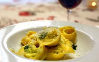 BOLOGNA, ITALY - MARCH 30: Hand-made tortellini filled with ricotta and parsley is served with a generous sprinkling of Parmesan cheese and red wine after a cooking lesson at Il Salotto di Penelope on March 30, 2017 in Bologna, Italy. Il Salotto di Penelope (Penelope's Lounge) is a private cooking school where Italian gourmet cooks Barbara Zaccagni and Valeria Hensemberger offer classes in preparing traditional Italian cuisine alongside their insights on Emilia Romagna culture and gastronomy. At the end of the lesson, participants get to eat what they prepared, served with a bottle of classic local wine. (Photo by David Silverman/Getty Images)