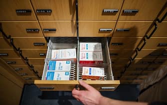 03 May 2023, Saxony, Leipzig: A pharmacist opens a drawer with antibiotic juices for children. The German Pharmacists' Association (ABDA) has criticized politicians in view of the shortages of medicines. Photo: Jan Woitas/dpa (Photo by Jan Woitas/picture alliance via Getty Images)