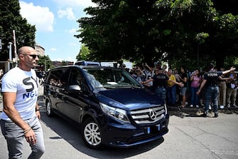 A funeral car transporting the body of Italian businessman and former prime minister Silvio Berlusconi exits the San Raffaele hospital, following in death, in Milan on June 12, 2023. Italy's former prime minister Silvio Berlusconi has died aged 86, his spokesman confirmed to AFP on June 12, 2023. The billionaire media mogul was admitted to a Milan hospital on June 9 for what aides said were pre-planned tests related to his leukemia. (Photo by GABRIEL BOUYS / AFP)