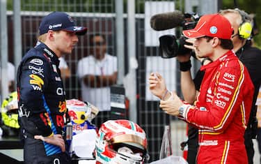 AUTODROMO INTERNAZIONALE ENZO E DINO FERRARI, ITALY - MAY 19: Max Verstappen, Red Bull Racing, 1st position, and Charles Leclerc, Scuderia Ferrari, 3rd position, tak in Parc Ferme during the Emilia Romagna GP at Autodromo Internazionale Enzo e Dino Ferrari on Sunday May 19, 2024 in imola, Italy. (Photo by Steven Tee / LAT Images)