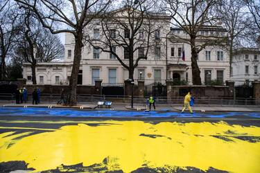 LONDON, ENGLAND - FEBRUARY 23: In this handout provided by Led By Donkeys, Activists from political campaign group Led By Donkeys, pour paint onto the road to create a giant Ukrainian flag outside the Russian Embassy on February 23, 2023 in London, England. The group created the flag using washable paint poured onto the road and then driven through by passing vehicles to show solidarity with Ukraine on the eve of the one year mark since the Russian invasion of Ukraine began. (Photo by Handout/Led By Donkeys via Getty Images)