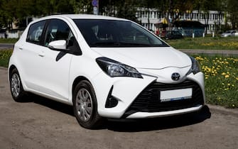 Minsk, Belarus, May 17, 2024 - Compact japanese white Toyota Yaris is parking on the street. Front side view.