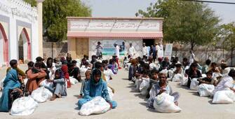 epa11262168 People receive free food rations distributed by the local Dua Foundation (DF) non-governmental organization during the holy fasting month of Ramadan, in Dahli, Tharparkar district, Sindh province, Pakistan, 06 April 2024. The Muslims' holy month of Ramadan is the ninth month in the Islamic calendar and it is believed that the revelation of the first verse in the Koran was during its last 10 nights. It is celebrated yearly by praying during the night time and abstaining from eating, drinking, and sexual acts during the period between sunrise and sunset. It is also a time for socializing, mainly in the evening after breaking the fast and a shift of all activities to late in the day in most countries.  EPA/REHAN KHAN