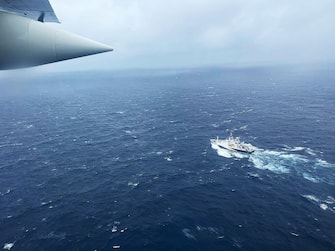 epa10706581 A handout photo made available by the US Coast Guard shows a Coast Guard Air Station Elizabeth City, North Carolina HC-130 Hercules airplane flies over the French research vessel, L'Atalante approximately 900 miles East of Cape Cod during the search for the 21-foot submersible, Titan, in Boston, Massachusetts, USA, 21 June 2023 (issued 22 June 2023). The United States Coast Guard, along with Canadian authorities, is searching the ocean depths for a submersible with Ocean Gate Expeditions, carrying tourists visiting the Titanic wreckage, 900 miles (1500 km) off the coast of Cape Cod, that lost contact on 18 June 2023.  EPA/PETTY OFFICER 1ST CLASS AMBER HOWIE HANDOUT  HANDOUT EDITORIAL USE ONLY/NO SALES