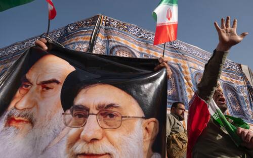 An Iranian protester shouts anti-U.S. and anti-Israeli slogans while standing next to the portraits of Iran's Supreme Leader, Ayatollah Ali Khamenei, and late leader, Ayatollah Ruhollah Khomeini, during a protest to condemn the U.S. attacks on Iran's nuclear facilities in downtown Tehran, Iran, on June 22, 2025, amid the Iran-Israel war. (Photo by Morteza Nikoubazl/NurPhoto via Getty Images)