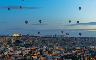GOREME/TURKEY - June 29, 2022:  hot air balloons fly at sunrise