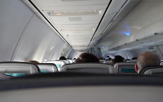 Passengers traveling by plane, shot from the inside of an airplane. Interior of a commercial airplane.