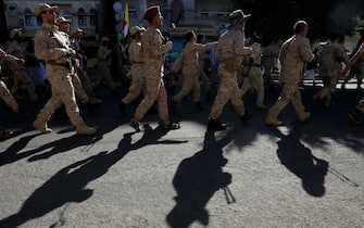 epa10915222 Houthi fighters march during a military parade in solidarity with Palestinians in the Gaza Strip, in Sana'a, Yemen, 12 October 2023. The top leader of the Houthis movement, Abdul-Malik al-Houthi, has warned that his movement will stand ready to engage in hostilities against Israel should the United States directly back the Israeli military campaign on the Gaza Strip. Thousands of Israelis and Palestinians have died since the militant group Hamas launched an unprecedented attack on Israel from the Gaza Strip on 07 October 2023, leading to Israeli retaliation strikes on the Palestinian enclave.  EPA/YAHYA ARHAB