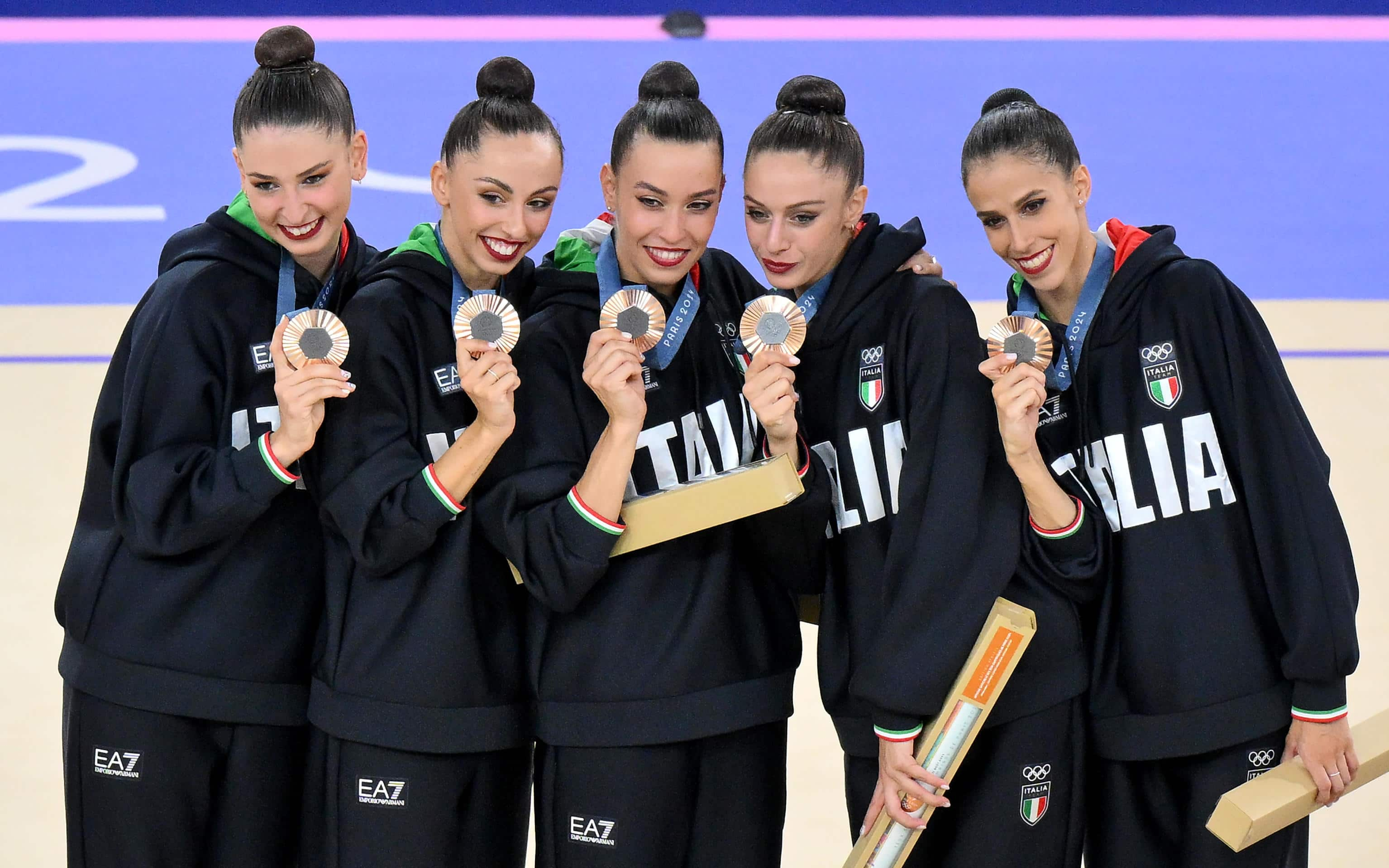 Italy's gymnasts, Martina Centofanti, Agnese Duranti, Alessia Maurelli, Daniela Mogurean and Laura Paris, celebrate on the podium after winning the bronze medal in the Group All-Around Final of the Rhythmic Gymnastics competitions in the Paris 2024 Olympic Games, at the La Chapelle Arena in Paris, France, 10 August 2024. ANSA/ETTORE FERRARI