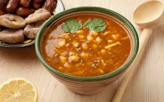 Bowl of Moroccan harira soup, lemon, dates and figs for iftar