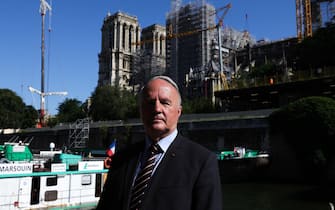 epa10739063 General Jean-Louis Georgelin, who oversees the reconstruction of the Notre-Dame de Paris Cathedral, poses for the camera in front of Notre Dame Cathedral after the installation of the first framework in Paris, France, 11 July 2023. The oak trusses of the framework are 14 to 16 metres wide and 12 to 13 metres high and weigh between 7 and 7.5 tons, and are the main framework for the Cathedral's spire. Since the fire which devastated the cathedral on 15 April 2019, hundreds of people are working on its reconstruction with the target to reopen the Cathedral before the end of 2024.  EPA/TERESA SUAREZ