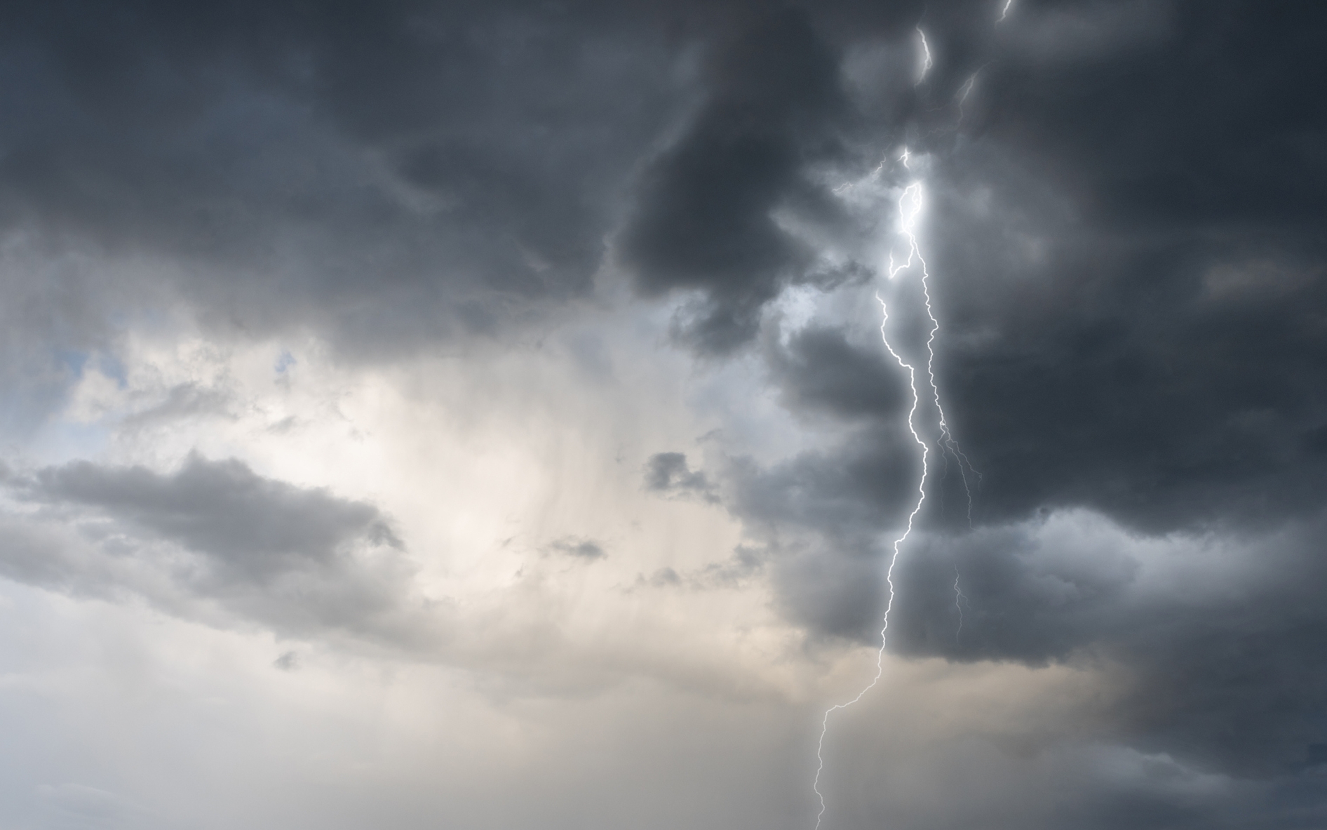 Cloud storm sky with thunderbolt over the village in rural scene.