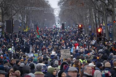 epa10415855 Protesters demonstrate during a national strike against the government's reform of the pension system, in Paris, France, 19 January 2023. The French government plans to delay the minimum retirement age from 62 to 64 by 2030.  EPA/YOAN VALAT