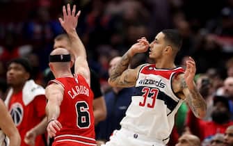 WASHINGTON, DC - JANUARY 11: Kyle Kuzma #33 of the Washington Wizards follows his game winning shot in front of Alex Caruso #6 of the Chicago Bulls during the Wizards 100-97 win at Capital One Arena on January 11, 2023 in Washington, DC. NOTE TO USER: User expressly acknowledges and agrees that, by downloading and or using this photograph, User is consenting to the terms and conditions of the Getty Images License Agreement. (Photo by Rob Carr/Getty Images)