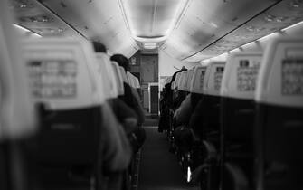 Inside the passenger plane inside the cabin in black and white color
