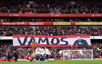 Arsenal and Leeds United players line up as fans hold up a banner for Arsenal manager Mikel Arteta during the Premier League match at the Emirates Stadium, London. Picture date: Saturday April 1, 2023.