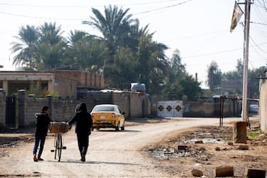 Residents walk in the village of Albu Bali in the Dyala province northeast of the Iraqi capital Baghdad, where attacks by members of the Islamic State (IS) group occur, on January 12, 2023. - Iraq has come a long way since major fighting ended over five years ago against the Islamic State (IS) group, putting an end to the their self-declared "caliphate" which once stretched across swathes of Iraq and Syria. But periodic attacks still claim lives among Iraq's war-weary citizens who have endured decades of conflict which flared especially after a 2003 US-led invasion toppled dictator Saddam Hussein. (Photo by AHMAD AL-RUBAYE / AFP) (Photo by AHMAD AL-RUBAYE/AFP via Getty Images)