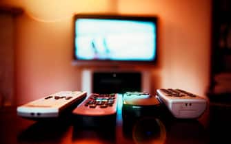 Four remote control devices and tv