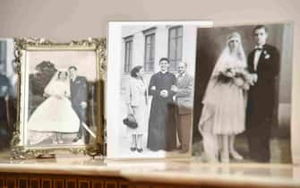 A photo of late priest Pino Puglisi (C) with his parents is pictured with other personal photos in the historic house museum and "Padre Nostro" welcome center in the Brancaccio district of Palermo, Sicily, on September 14, 2018 on the eve of the Pope's visit to the Diocese. - Pope Francis is to pay a one-day pastoral visit on September 15 the Dioceses of Piazza Armerina and Palermo in Sicily, on the occasion of the 25th anniversary of the killing by the mafia of Sicilian priest Pino Puglisi. (Photo by Andreas SOLARO / AFP)        (Photo credit should read ANDREAS SOLARO/AFP via Getty Images)