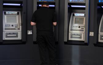 epa03426469 A customer uses an ATM machine at a Barclays bank branch in London, Britain, 09 October 2012. Barclays Bank announced 09 October it has agreed to buy ING Direct UK. The move will bring a further 1.5 million customers to Barclays.  EPA/ANDY RAIN