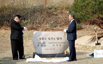 North Korean leader Kim Jong Un and South Korean President Moon Jae-in during a tree planting ceremony during the Inter-Korean Summit on April 27, 2018 in Panmunjom, South Korea. Kim and Moon meet at the border today for the third-ever Inter-Korean summit talks after the 1945 division of the peninsula, and first since 2007 between then President Roh Moo-hyun of South Korea and Leader Kim Jong-il of North Korea.  (Photo by Inter Korean Press Corp/NurPhoto via Getty Images)