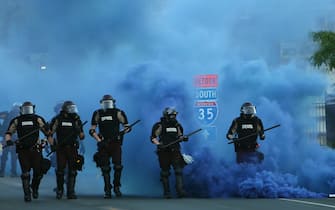 MINNEAPOLIS, MINNESOTA - MAY 30: Police advance on demonstrators who are protesting the killing of George Floyd on May 30, 2020 in Minneapolis, Minnesota. Former Minneapolis police officer Derek Chauvin was arrested for Floyd's death and is accused of kneeling on Floyd's neck as he pleaded with him about not being able to breathe. Floyd was pronounced dead a short while later. Chauvin and three other officers, who were involved in the arrest, were fired from the police department after a video of the arrest was circulated.  (Photo by Scott Olson/Getty Images)