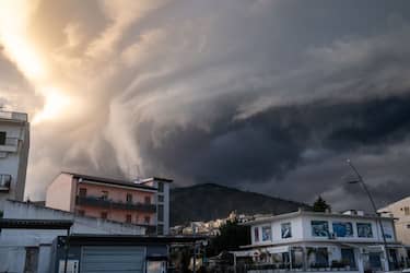 TREBISACCE, CALABRIA, ITALY - 2023/03/04: A sudden, rapidly changing cloud front appears to form a vortex over the houses of Trebisacce, in Calabria, southern Italy. The sudden change in climatic conditions is due to a clash between cold air coming from the North and warm air coming from the sea and from the South. Bad weather is hitting Italy with a cold front and sudden and violent rainfall. (Photo by Alfonso Di Vincenzo/KONTROLAB/LightRocket via Getty Images)