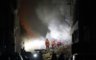 Rescue personnel work at the scene where a building collapsed in the southern French port city of Marseille  early on April 9, 2023. - A building in the southern French port city of Marseille collapsed, police told AFP early on April 9, though it was unclear whether there were any victims. (Photo by NICOLAS TUCAT / AFP) / The erroneous mention[s] appearing in the metadata of this photo by NICOLAS TUCAT has been modified in AFP systems in the following manner: [April 9] instead of [March 9]. Please immediately remove the erroneous mention[s] from all your online services and delete it (them) from your servers. If you have been authorized by AFP to distribute it (them) to third parties, please ensure that the same actions are carried out by them. Failure to promptly comply with these instructions will entail liability on your part for any continued or post notification usage. Therefore we thank you very much for all your attention and prompt action. We are sorry for the inconvenience this notification may cause and remain at your disposal for any further information you may require. (Photo by NICOLAS TUCAT/AFP via Getty Images)