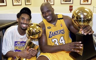 LOS ANGELES, UNITED STATES:  Kobe Bryant (L) of the Los Angeles Lakers holds the Larry O'Brian trophy as teammate Shaquille O'Neal (L) hold the MVP trophy after winning the NBA Championship against Indiana Pacers 19 June, 2000, after game six of the NBA Finals at Staples Center in Los Angeles, CA. The Lakers won the game 116-111 to take the NBA title 4-2 in the best-of-seven series. (ELECTRONIC IMAGE)  AFP PHOTO (Photo credit should read AFP/AFP via Getty Images)