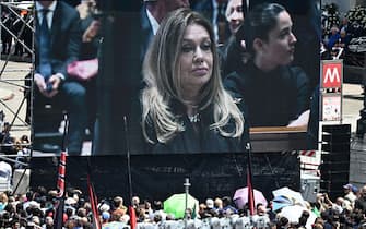 A view shows a live broadcast of the second wife of Italy's former prime minister and media mogul Silvio Berlusconi, on a giant screen installed at Piazza Duomo in Milan on June 14, 2023 for people to follow the state funeral for Berlusconi. (Photo by GABRIEL BOUYS / AFP) (Photo by GABRIEL BOUYS/AFP via Getty Images)