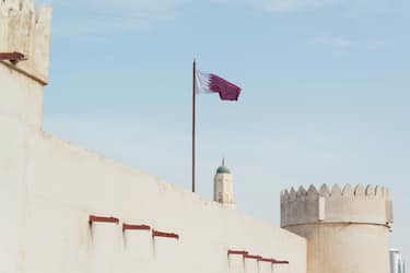 Qatar national flag on Ancient Al Koot Fort in Doha