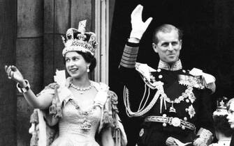 File photo dated 02/06/53 of Queen Elizabeth II, wearing the Imperial State Crown, and the Duke of Edinburgh, dressed in uniform of Admiral of the Fleet, waving from the balcony to the onlooking crowds at the gates of Buckingham Palace after the Coronation. The 1953 coronation was a morale boost in the tough post-war years as millions celebrated the historic day. Elizabeth II was crowned in a deeply religious ceremony in Westminster Abbey on June 2 1953. Issue date: Tuesday April 25, 2023.
