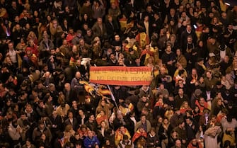 MADRID, SPAIN - 2023/11/09: Demonstrators are seen holding a Spanish Flag with the message "may the traitor to Spain find no forgiveness" during a protest in front of socialist party PSOE headquarters in Ferraz street for the seventh consecutive day of protests following the recent agreement between PSOE and Junts party, which unfolded today in Brussels. Thousands responded to a call by far right groups to protest the approval of an amnesty for Catalan separatist leaders which is included in the agreement and guarantees the investiture of the socialist candidate Pedro Sanchez. (Photo by Marcos del Mazo/LightRocket via Getty Images)