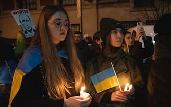 epa10487058 People gather outside the Russian Consulate to show their support for Ukraine during a candlelight vigil in New York, New York, USA, 23 February 2023. 24 February is the one year anniversary of Russia's invasion of Ukraine.  EPA/SARAH YENESEL