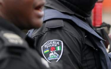 epa09534457 A policeman is seen wearing a hood during a memorial protest for a military attack at the Lekki tollgate in Lagos, Nigeria, 20 October 2021. Police disperse youths who held a memorial protest in Lagos to commemorate a military attack during the protest against police brutality on 20 October 2020.  EPA/AKINTUNDE AKINLEYE