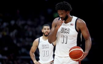 ABU DHABI, UNITED ARAB EMIRATES - JULY 17:  Joel Embiid #11 of the United States prepares to take a free throw as Jayson Tatum #10 of the United States looks on during the first half of an exhibition game between the United States and Serbia ahead of the Paris Olympic Games at Etihad Arena on July 17, 2024 in Abu Dhabi, United Arab Emirates. (Photo by Christopher Pike/Getty Images)