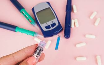diabetes pen injection needle, syringes lie on pink background, diabetes disease concept, stop diabetes.