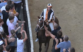 The monkey of Contranda of Lupa  named  Dino Pes    of nickname Velluto on  Benitos  wins the historical Italian horse race Palio di Siena, in Siena, Italy, 17 August 2024. The traditional horse race takes place on 17 August as the 'Palio dell'Assunta' during the holidays for the Assumption of Mary.
ANSA/CLAUDIO GIOVANNINI