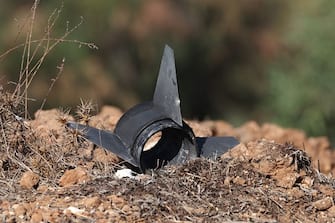 A picture shows the remains of a rocket launched from Gaza after it was intercepted by the Iron Dome system and fell in Sderot on Ocyober 15, 2023. Israeli forces were on October 15, readying for a looming Gaza ground invasion aimed at destroying Hamas, the Palestinian Islamist militant group that unleashed the bloodiest attack in the country's history. (Photo by JACK GUEZ / AFP) (Photo by JACK GUEZ/AFP via Getty Images)