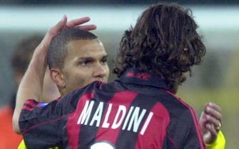 DOR02 - 20020404 - DORTMUND, GERMANY : AC Milan's Paolo Maldini (R) congratulates Borussia Dortmund's Marcio Amoroso (L) after the final whistle of the UEFA Cup semi final, first leg soccer match in Dortmund's Westphalia stadium on Thursday 04 April 2002. Amoroso's first-half hat-trick all but thrust Dortmund into the UEFA Cup final as they beat AC Milan 4-0.    EPA PHOTO  DPA / ROLAND WEIHRAUCH
